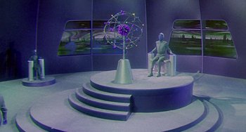 Movie still from “This Island Earth” (1955), directed by Joseph M. Newman – A stage with a statue sitting on top of it; Wide shot, High angle