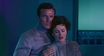 Movie still from “This Island Earth” (1955), directed by Joseph M. Newman – A man and a woman standing next to each other; Medium shot, Low angle