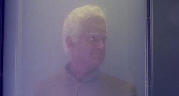 Movie still from “This Island Earth” (1955), directed by Joseph M. Newman – A man with white hair is looking into the distance; Close Up shot, Low angle