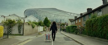 Movie still from “This Must Be the Place” (2011), directed by Paolo Sorrentino – A person walking down a street with a cart; Extreme Wide shot, Low angle