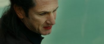 Movie still from “This Must Be the Place” (2011), directed by Paolo Sorrentino – A person's face with a green background; Close Up shot, Low angle