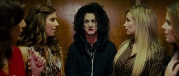 Movie still from “This Must Be the Place” (2011), directed by Paolo Sorrentino – Three women standing next to each other in front of a wooden wall; Medium shot, Over the shoulder angle