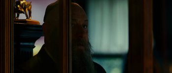 Movie still from “This Must Be the Place” (2011), directed by Paolo Sorrentino – A man with a long beard looking out of a window; Close Up shot, Over the shoulder angle