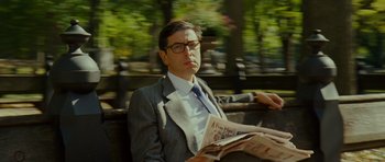 Movie still from “This Must Be the Place” (2011), directed by Paolo Sorrentino – A man sitting on a park bench reading a newspaper; Medium shot, Low angle