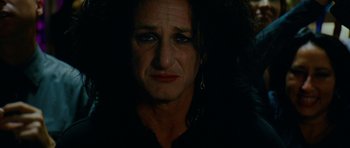 Movie still from “This Must Be the Place” (2011), directed by Paolo Sorrentino – A person wearing a black shirt; Close Up shot, High angle