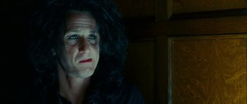 Movie still from “This Must Be the Place” (2011), directed by Paolo Sorrentino – A man with long black hair is looking at the camera; Close Up shot, Low angle