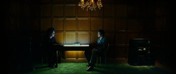 Movie still from “This Must Be the Place” (2011), directed by Paolo Sorrentino – Two people sitting at a table in front of one another; Wide shot, Over the shoulder angle
