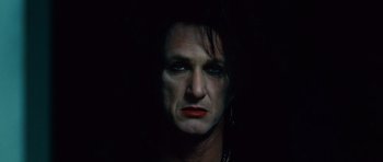 Movie still from “This Must Be the Place” (2011), directed by Paolo Sorrentino – A man with black hair and red lipstick; Close Up shot, Low angle
