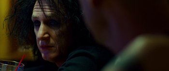 Movie still from “This Must Be the Place” (2011), directed by Paolo Sorrentino – A woman's face in a dark room; Close Up shot, Over the shoulder angle