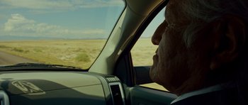 Movie still from “This Must Be the Place” (2011), directed by Paolo Sorrentino – An older man driving a car in the desert; Close Up shot, Over the shoulder angle
