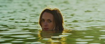 Movie still from “This Must Be the Place” (2011), directed by Paolo Sorrentino – A woman in a body of water looking at the camera; Close Up shot, Low angle