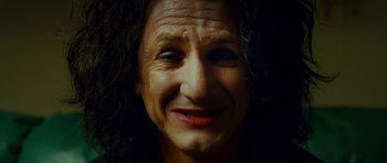 Movie still from “This Must Be the Place” (2011), directed by Paolo Sorrentino – An older woman with curly black hair smiling for the camera; Close Up shot, Low angle