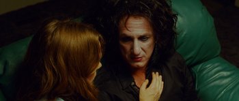 Movie still from “This Must Be the Place” (2011), directed by Paolo Sorrentino – A woman standing next to a man with long black hair; Close Up shot, Over the shoulder angle