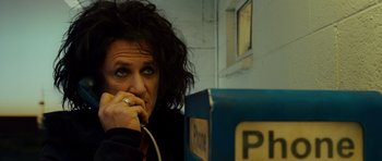 Movie still from “This Must Be the Place” (2011), directed by Paolo Sorrentino – A woman sitting in front of a phone booth; Close Up shot, Low angle