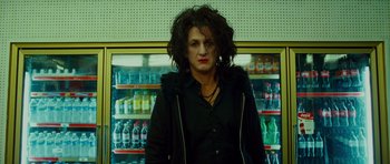 Movie still from “This Must Be the Place” (2011), directed by Paolo Sorrentino – A woman standing in front of a shelf filled with drinks; Close Up shot, Low angle