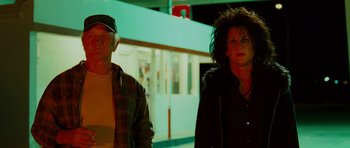 Movie still from “This Must Be the Place” (2011), directed by Paolo Sorrentino – A man and a woman walking down a street; Medium shot, Low angle