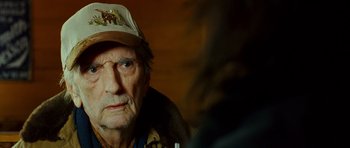 Movie still from “This Must Be the Place” (2011), directed by Paolo Sorrentino – An old man wearing a hat looking into the camera; Close Up shot, Over the shoulder angle