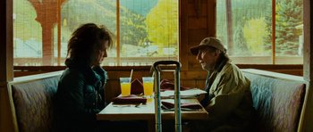 Movie still from “This Must Be the Place” (2011), directed by Paolo Sorrentino – A man and a woman sitting at a table with drinks; Medium shot, Over the shoulder angle