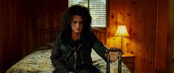 Movie still from “This Must Be the Place” (2011), directed by Paolo Sorrentino – A woman sitting on a bed with a cane; Medium shot, Low angle