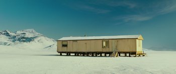 Movie still from “This Must Be the Place” (2011), directed by Paolo Sorrentino – An old mobile home in the middle of a snowy field; Extreme Wide shot, Low angle
