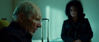 Movie still from “This Must Be the Place” (2011), directed by Paolo Sorrentino – An older man and a young woman sitting at a table; Close Up shot, Over the shoulder angle