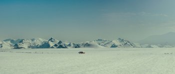 Movie still from “This Must Be the Place” (2011), directed by Paolo Sorrentino – A car is driving through a snow covered field; Extreme Wide shot, High angle
