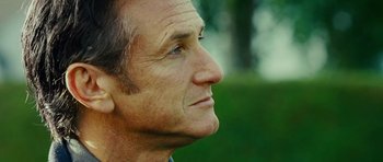 Movie still from “This Must Be the Place” (2011), directed by Paolo Sorrentino – An older man looking to his right side; Close Up shot, Over the shoulder angle
