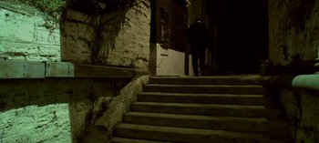 Movie still from “Three Monkeys” (2008), directed by Nuri Bilge Ceylan – A man walking up some stairs in the dark; Extreme Wide shot, High angle