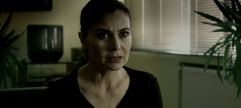 Movie still from “Three Monkeys” (2008), directed by Nuri Bilge Ceylan – A person wearing a black shirt; Close Up shot, Over the shoulder angle