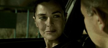 Movie still from “Three Monkeys” (2008), directed by Nuri Bilge Ceylan – A person wearing a black t - shirt; Close Up shot, Over the shoulder angle