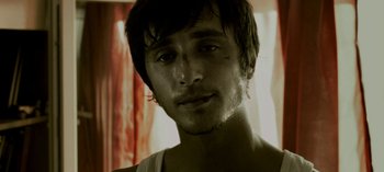 Movie still from “Three Monkeys” (2008), directed by Nuri Bilge Ceylan – A person wearing a shirt; Close Up shot, Low angle