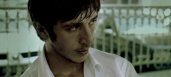 Movie still from “Three Monkeys” (2008), directed by Nuri Bilge Ceylan – A person wearing a white shirt; Close Up shot, Low angle