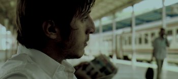 Movie still from “Three Monkeys” (2008), directed by Nuri Bilge Ceylan – A person holding something in his hand; Extreme Close Up shot, Low angle