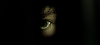 Movie still from “Three Monkeys” (2008), directed by Nuri Bilge Ceylan – A person's eye in the dark; Extreme Close Up shot, Overhead angle