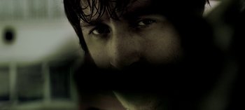 Movie still from “Three Monkeys” (2008), directed by Nuri Bilge Ceylan – A man's eyes and face; Extreme Close Up shot, Low angle