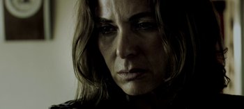 Movie still from “Three Monkeys” (2008), directed by Nuri Bilge Ceylan – A woman's face in the dark; Close Up shot, Low angle