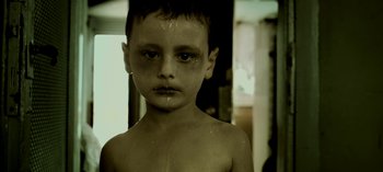 Movie still from “Three Monkeys” (2008), directed by Nuri Bilge Ceylan – A young boy is crying with tears coming from his eyes; Close Up shot, High angle