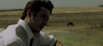 Movie still from “Three Monkeys” (2008), directed by Nuri Bilge Ceylan – A man in a white dress shirt and a white tie; Close Up shot, Low angle