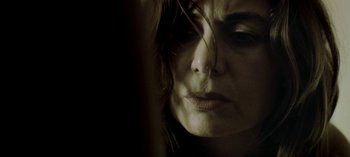 Movie still from “Three Monkeys” (2008), directed by Nuri Bilge Ceylan – A woman's face in the dark; Close Up shot, High angle