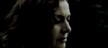 Movie still from “Three Monkeys” (2008), directed by Nuri Bilge Ceylan – A woman's face in the dark; Extreme Close Up shot, Low angle