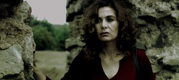 Movie still from “Three Monkeys” (2008), directed by Nuri Bilge Ceylan – A person with curly hair; Close Up shot, Low angle