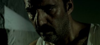 Movie still from “Three Monkeys” (2008), directed by Nuri Bilge Ceylan – A person with a beard; Extreme Close Up shot, Low angle