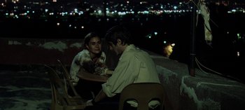 Movie still from “Three Monkeys” (2008), directed by Nuri Bilge Ceylan – A man and a woman are sitting at a table; Medium shot, High angle