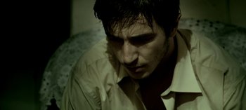 Movie still from “Three Monkeys” (2008), directed by Nuri Bilge Ceylan – A person wearing a shirt and tie; Close Up shot, High angle