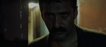 Movie still from “Three Monkeys” (2008), directed by Nuri Bilge Ceylan – A person with a beard; Close Up shot, Low angle