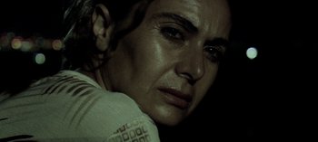 Movie still from “Three Monkeys” (2008), directed by Nuri Bilge Ceylan – A woman's face in the dark; Close Up shot, High angle