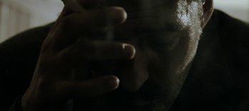 Movie still from “Three Monkeys” (2008), directed by Nuri Bilge Ceylan – A person with their hand on the wall; Extreme Close Up shot, Low angle