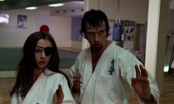 A man and a woman in white karate uniforms