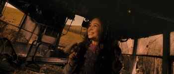 Movie still from “Tideland” (2005), directed by Terry Gilliam – A woman smiles while holding a microphone in her hand; Close Up shot, Over the shoulder angle