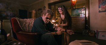 Movie still from “Tideland” (2005), directed by Terry Gilliam – A man and a little girl lighting a cigarette; Medium shot, Low angle